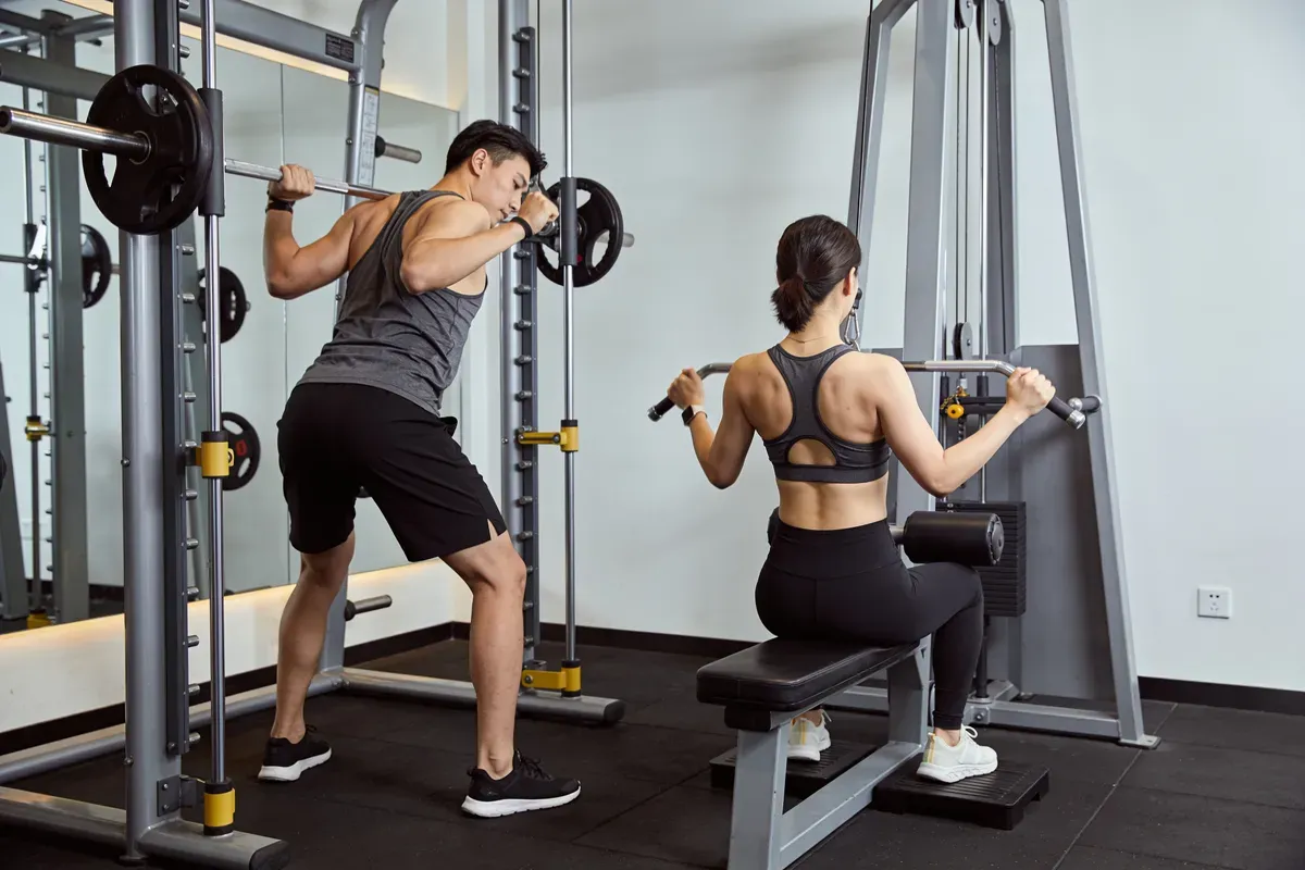 Homme exécutant un rowing barre buste penché en salle de musculation
